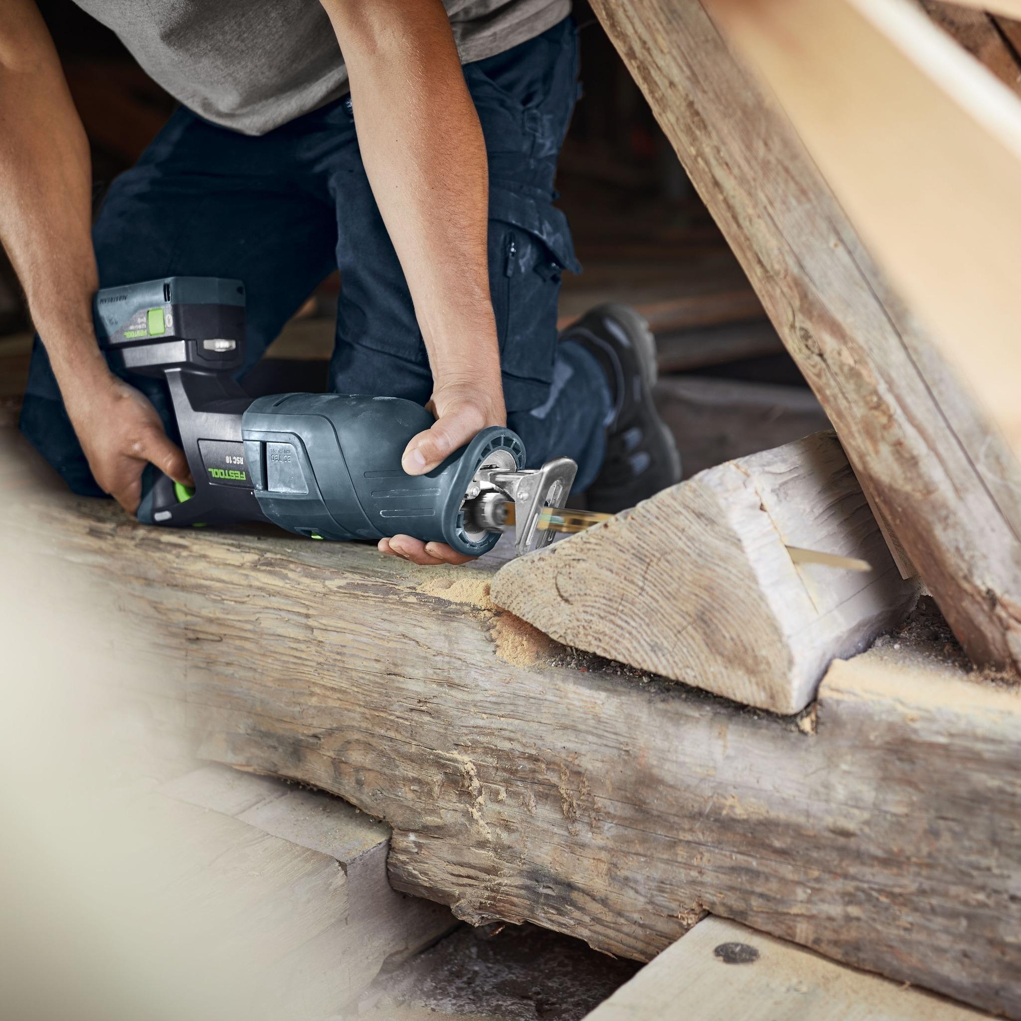 Person cutting wood with a battery sawzall