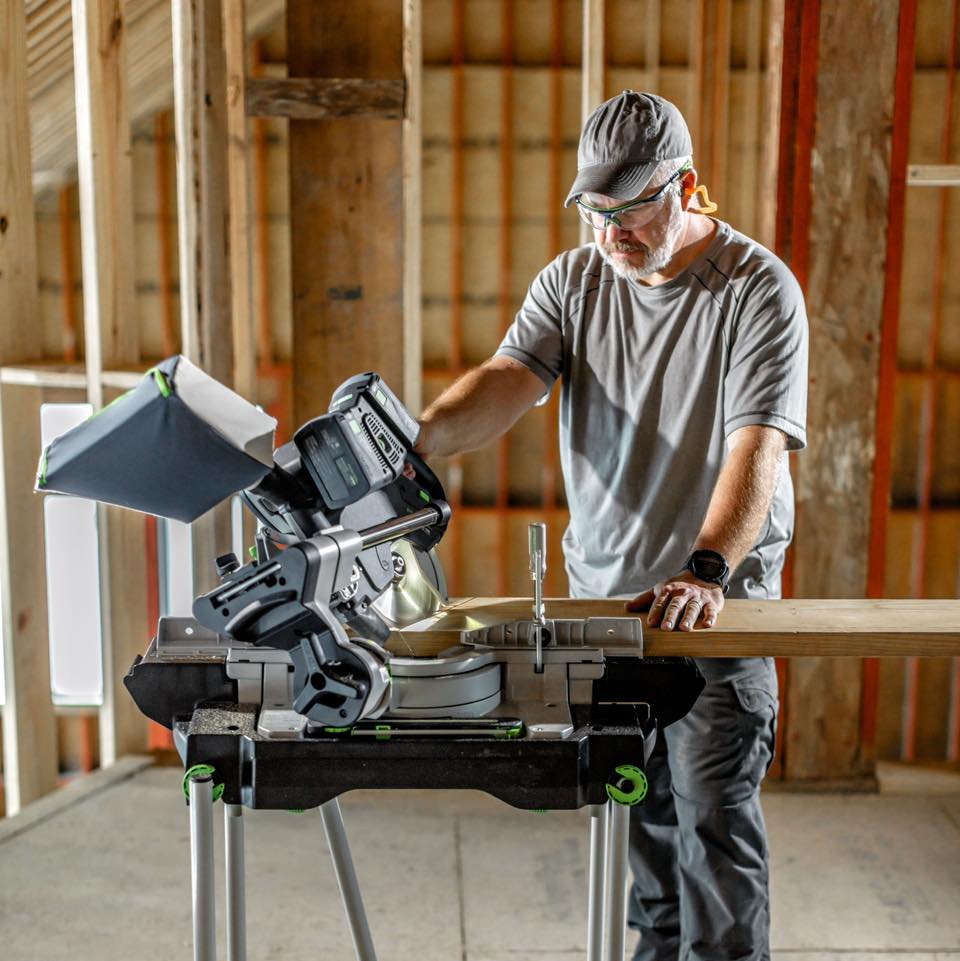 Person cutting wood with a table saw