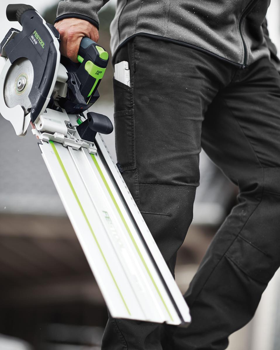 Man holding a circular saw with an alignment attachment