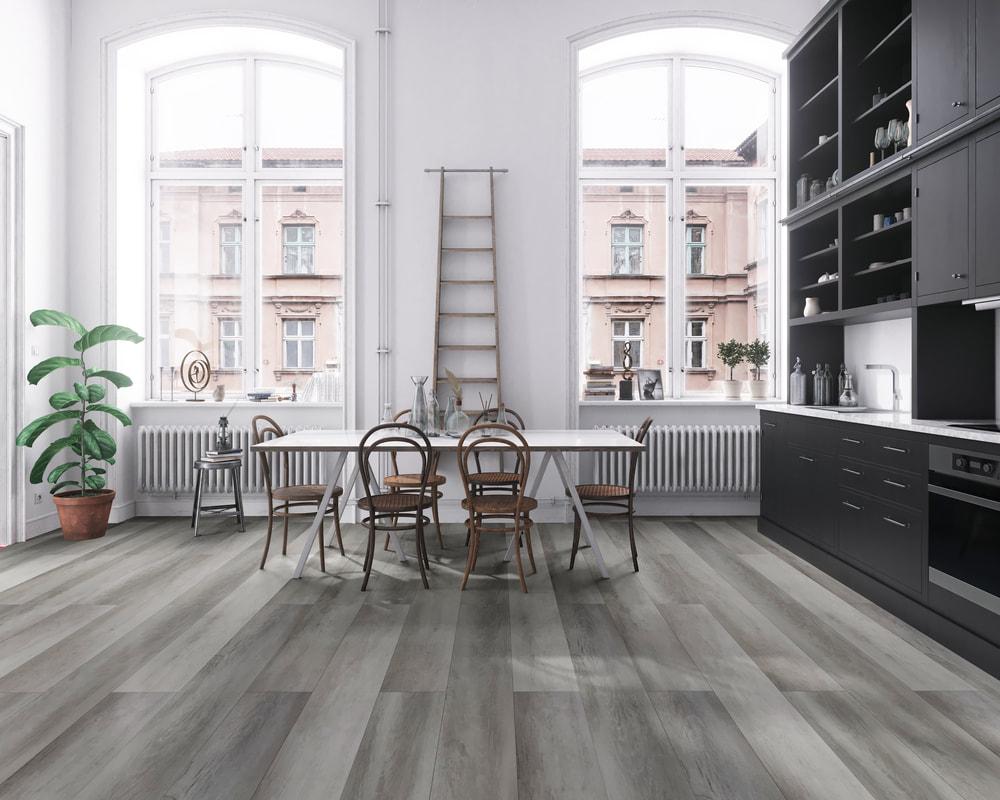 Open concept kitchen with tall ceilings and wood flooring