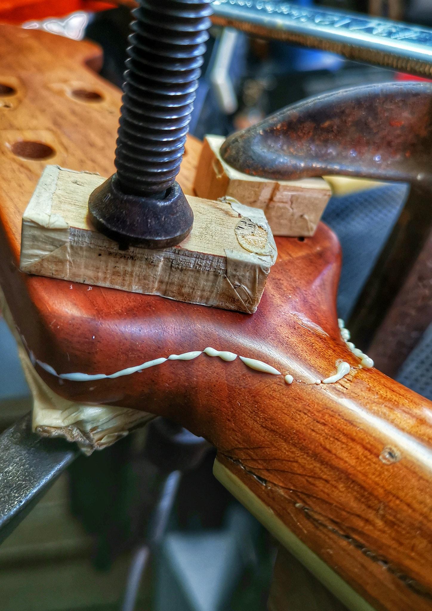 Guitar being made with clamps and wood glue