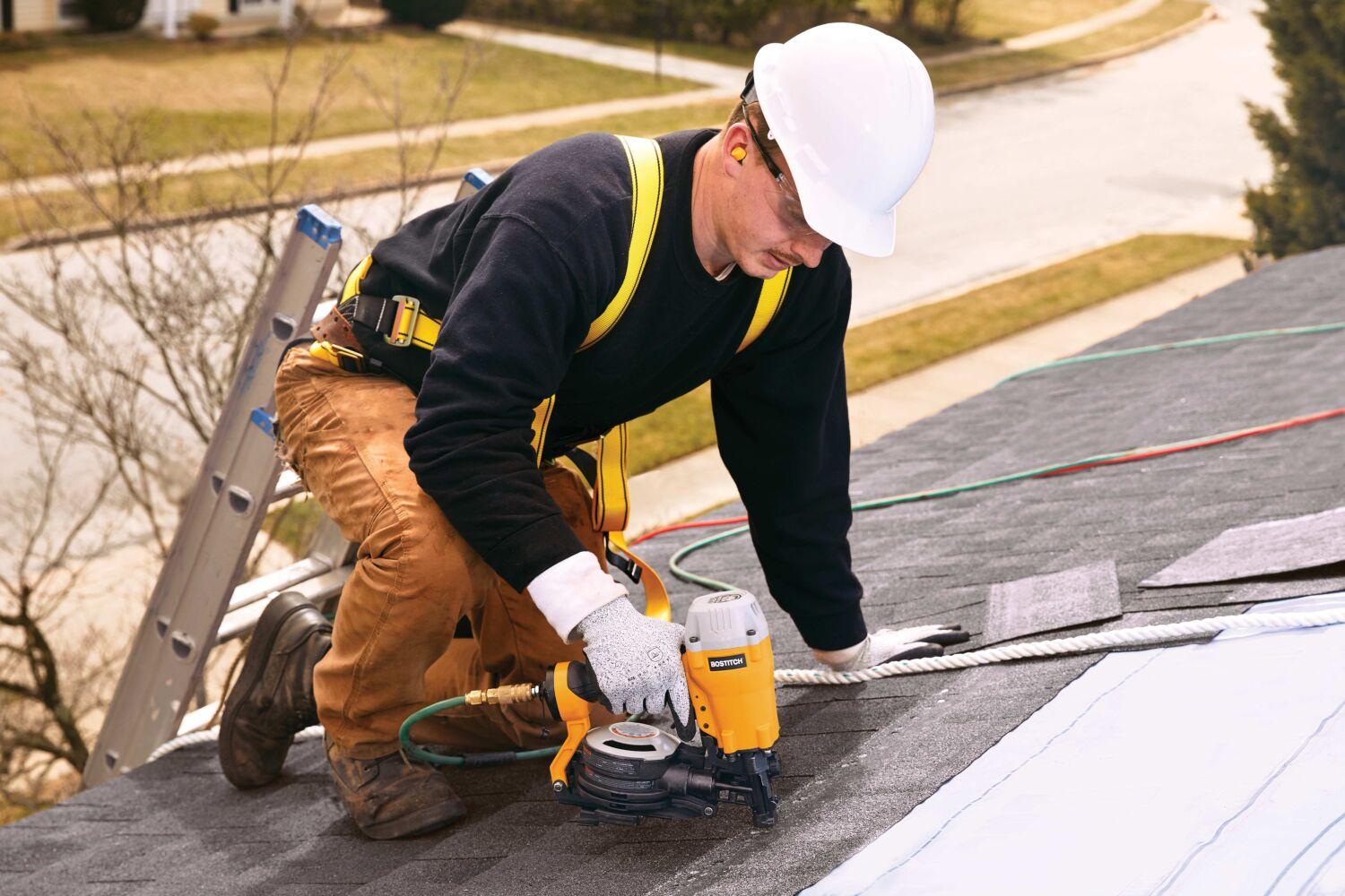 Nail gun being used to nail in roofing