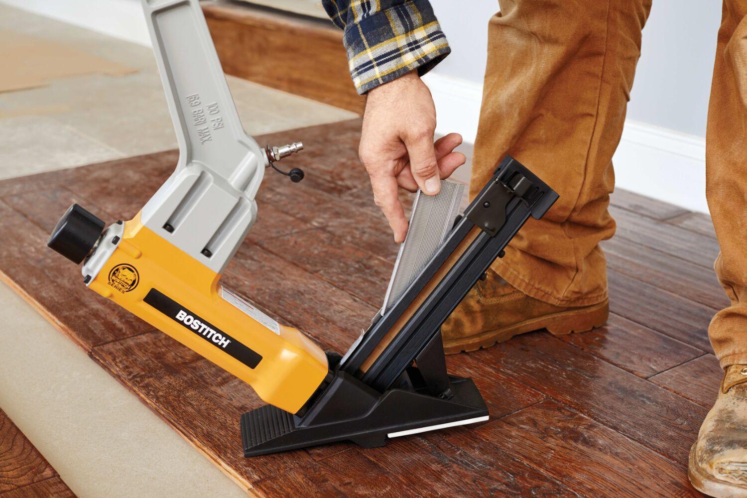 Bostich flooring tool in front of a person's feet