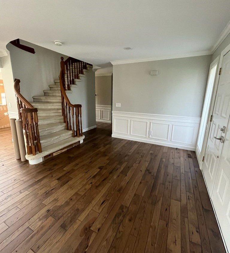 Oregon Trail flooring in an open room with stairs