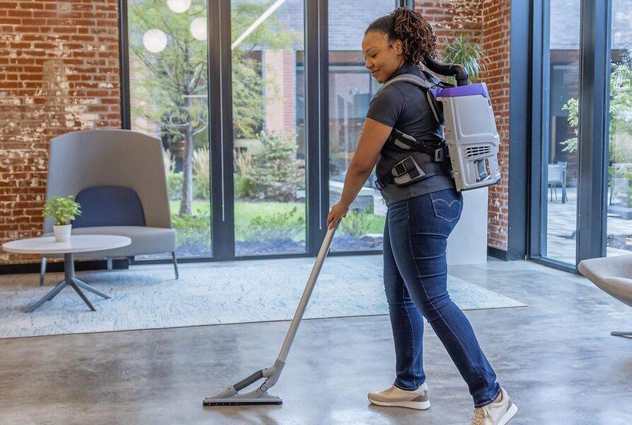 Woman walking with vacuum backpack