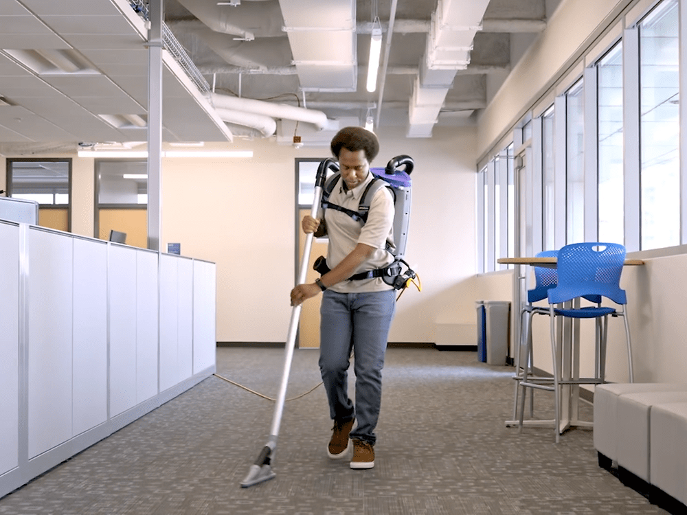 Man walking with vacuum backpack