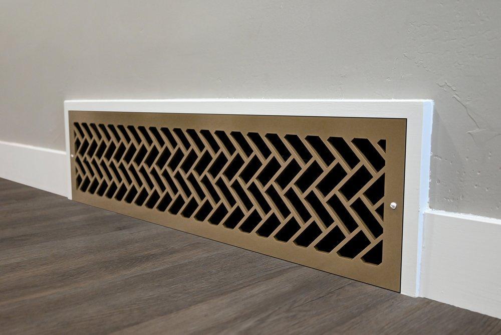 Herringbone patter floor vent on a wall