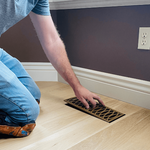 Curved floor vent being installed in a home